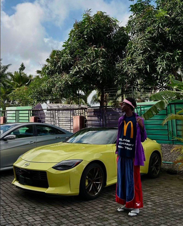 Kanann standing beside a lime green sports car